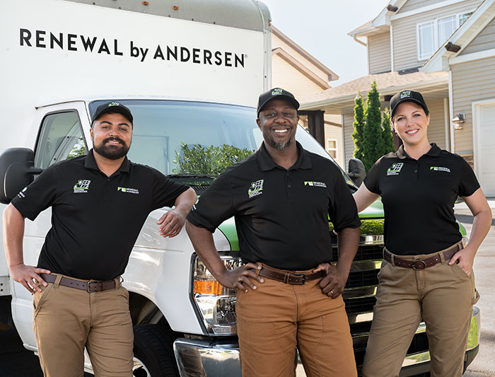 Three Renewal by Andersen installers standing in front of a company truck.