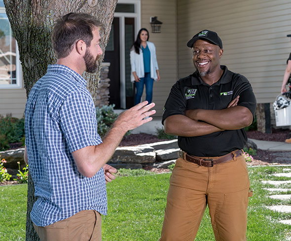 Patio door installer speaking to a homeowner.